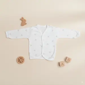 Soft white cotton, full-sleeve baby vest with tiny beige teddy bear print, featuring a front-open kimono style for infants 3 to 6 months