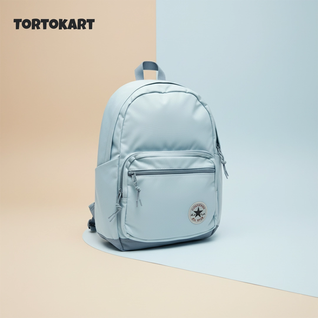 TORTKART Light Blue Converse-Style Backpack. Modern, waterproof bag with external pocket and patch logo, perfect for school, college, or casual travel.