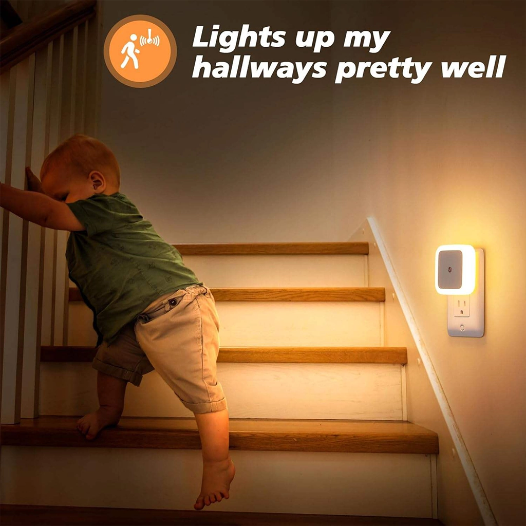 Automatic Plug-in Motion Sensor Night Light illuminating a staircase for child safety in a dark hallway.
