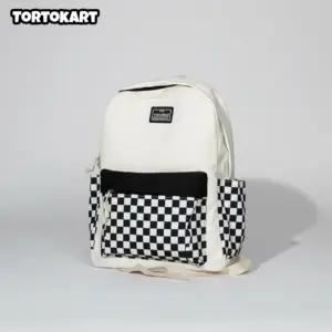 white and black checkerboard backpack with a solid black front pocket and side pockets, on a plain white background