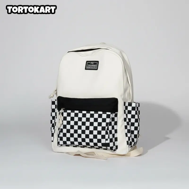 white and black checkerboard backpack with a solid black front pocket and side pockets, on a plain white background