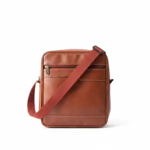 Front view of a brown textured leather side messenger bag with a wide adjustable reddish-brown canvas shoulder strap, featuring a zippered front pocket and a debossed Jeep logo at the bottom.