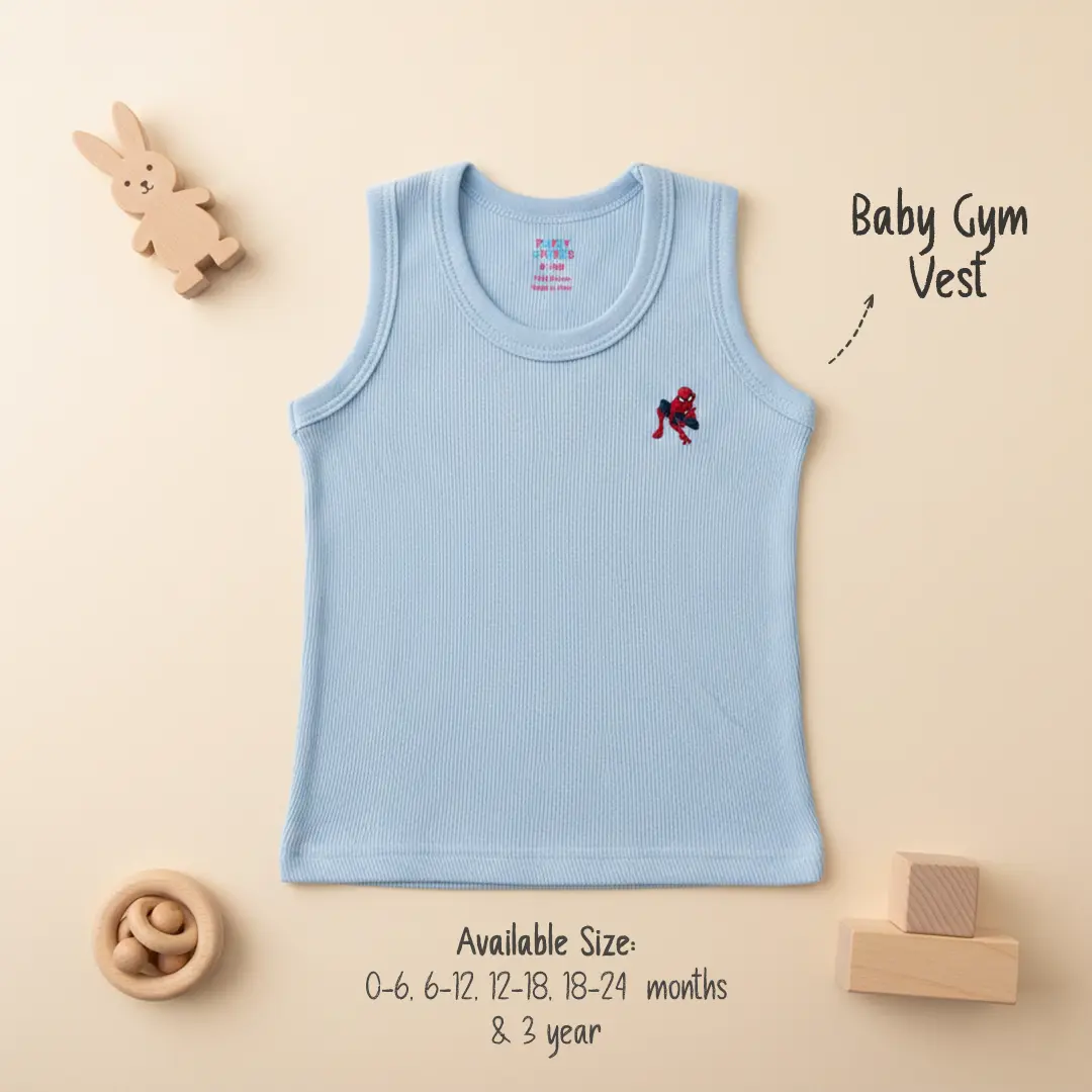 Light blue ribbed cotton baby gym vest from Puffy Cheeks featuring a small Spider-Man superhero embroidery on the chest, displayed on a beige background with wooden toys.