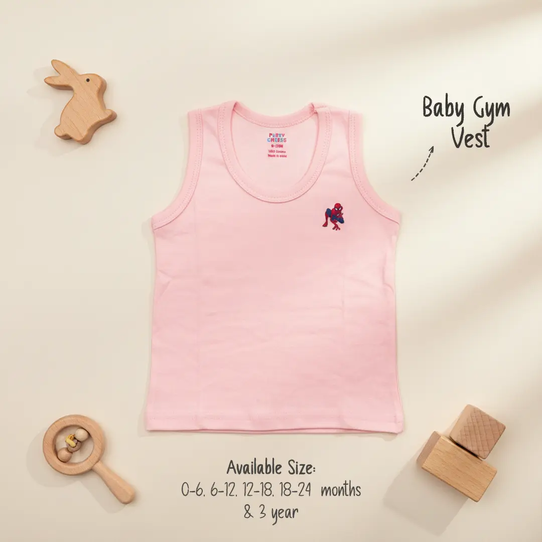 Light pink cotton baby gym vest from Puffy Cheeks featuring a small Spider-Man superhero embroidery on the chest, showcased on a neutral background with a wooden rabbit toy and blocks.