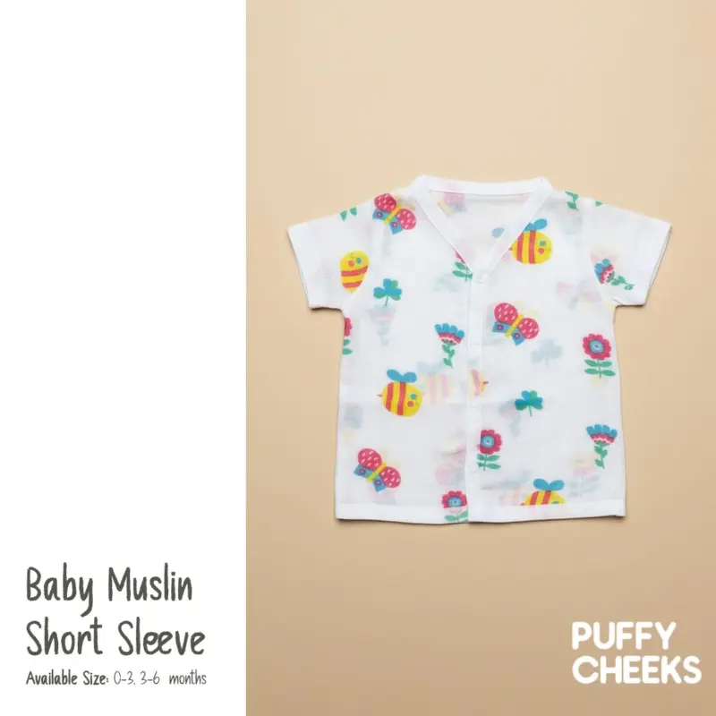 Puffy Cheeks baby muslin short sleeve shirt with colorful bee, butterfly, and flower print in white breathable fabric.