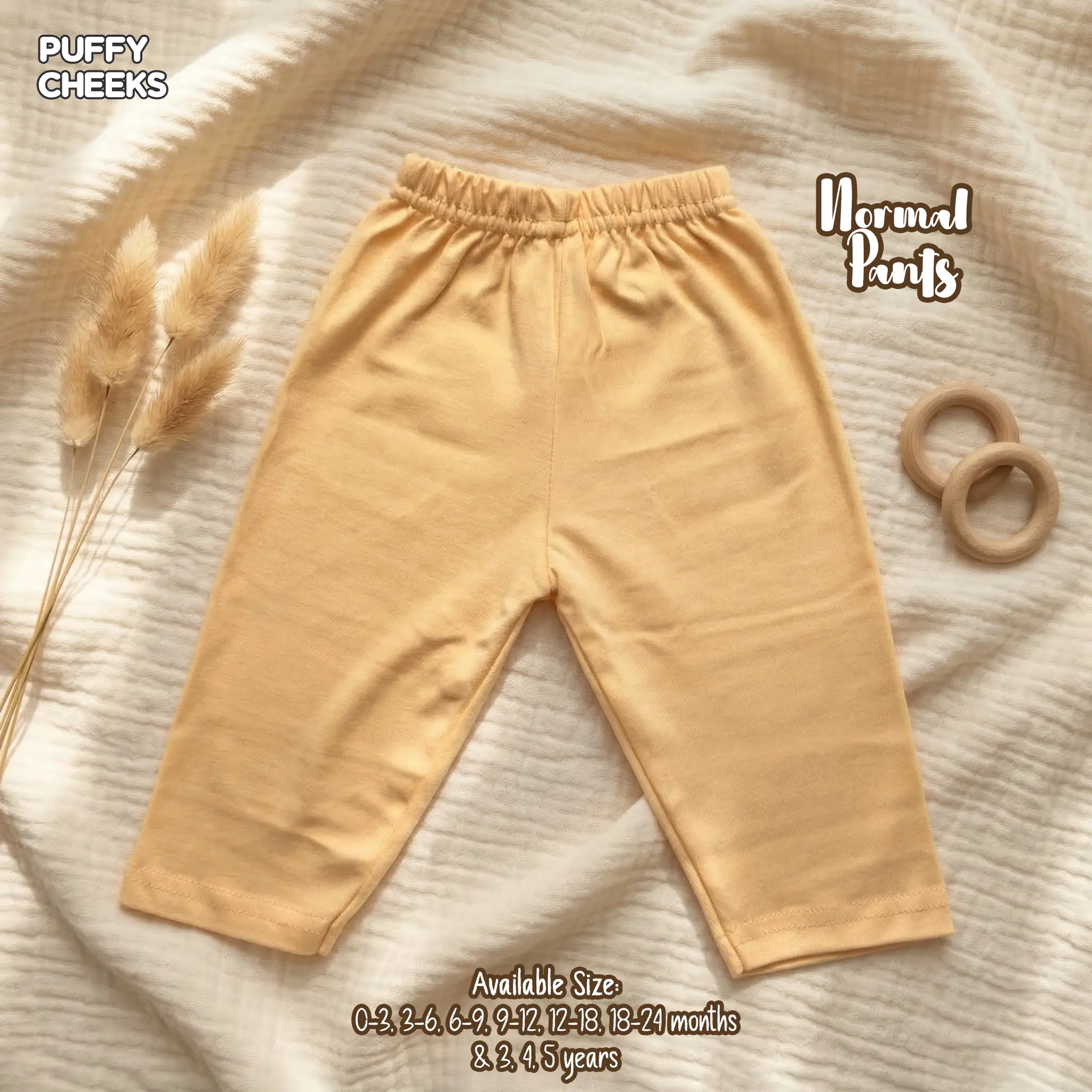 Puffy Cheeks plain pastel peach beige normal pants for babies made of soft breathable fabric.