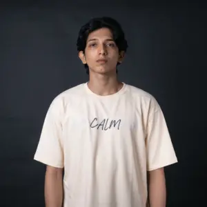 Detailed streetwear back graphic on Layered cream t-shirt featuring an orange flaming eastern dragon design with bold black typography.